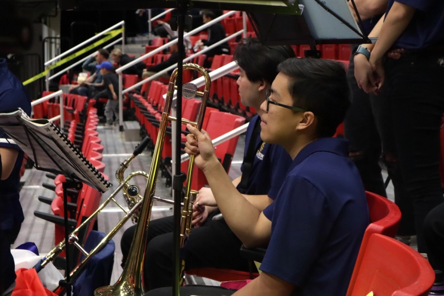 Boy holding trombone.