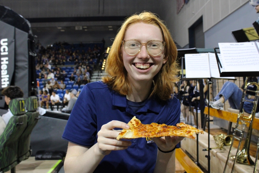 Girl holding pizza.