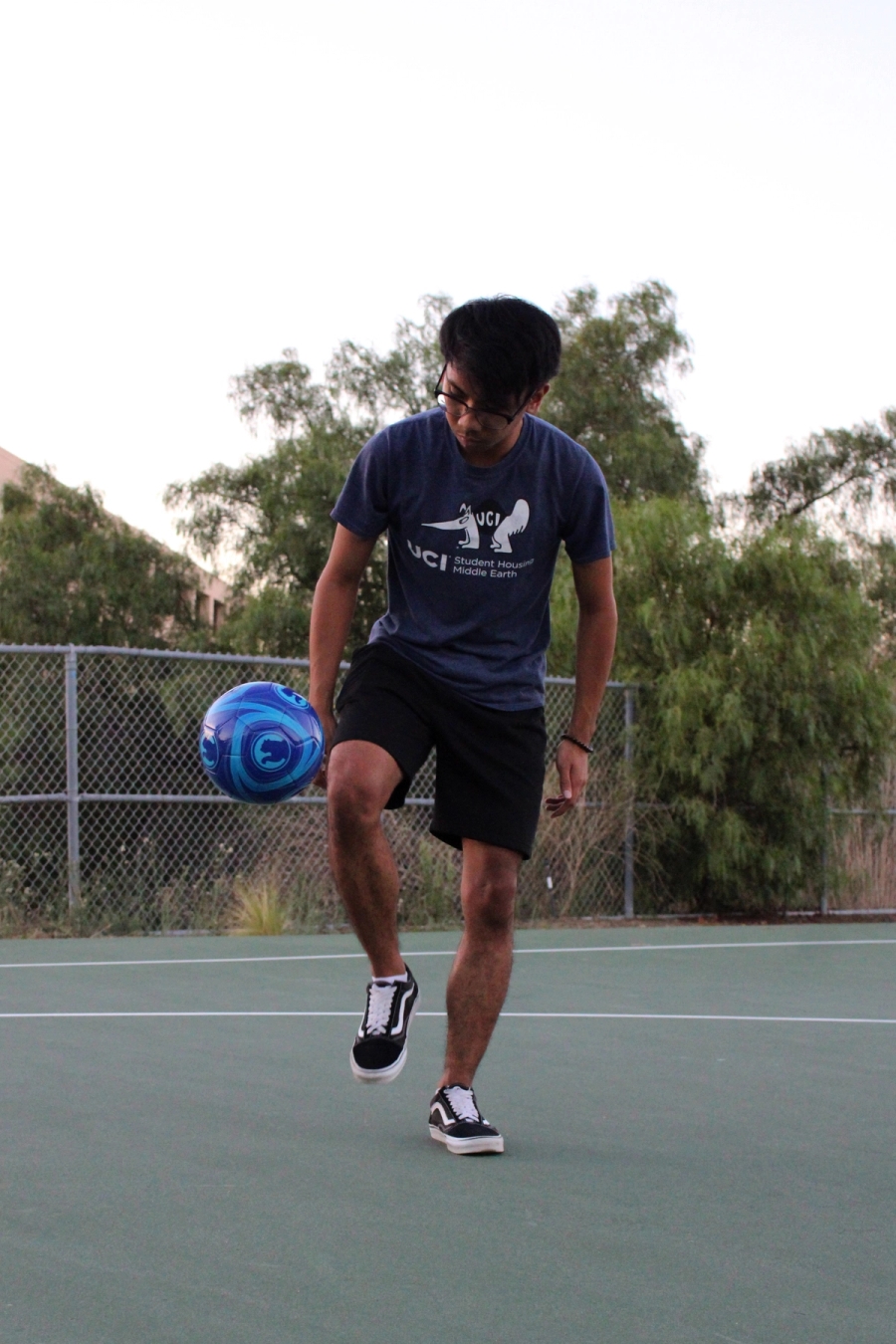 Boy kicking soccer ball.