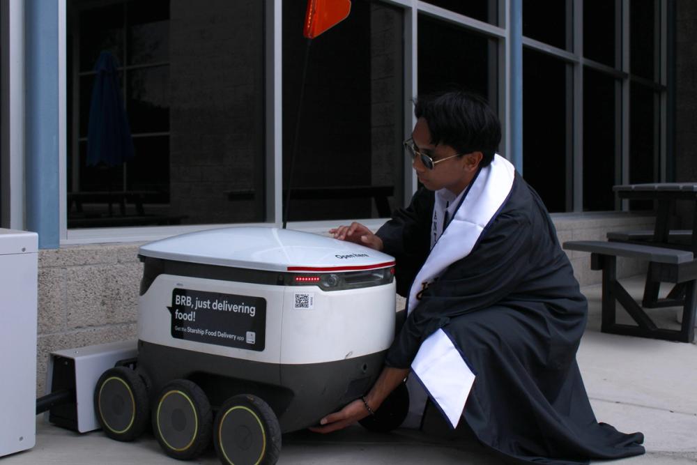 Boy tending to a ZotBot.