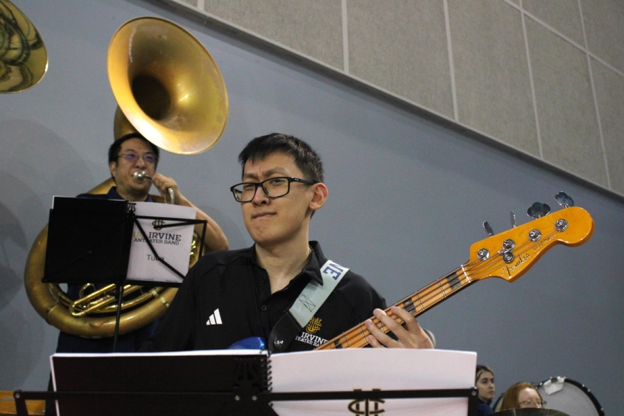 Man playing bass with serious face.
