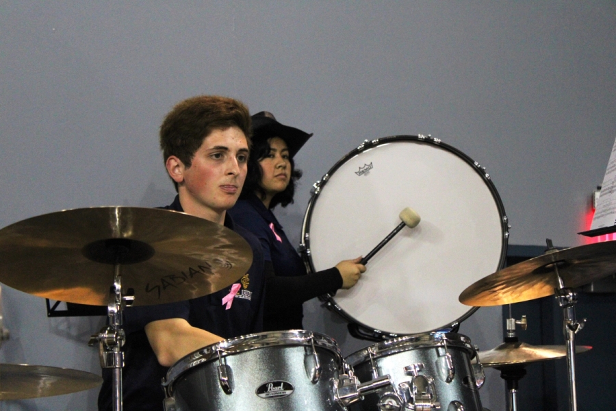 Boy on drums and girl with hat playing bass drum.