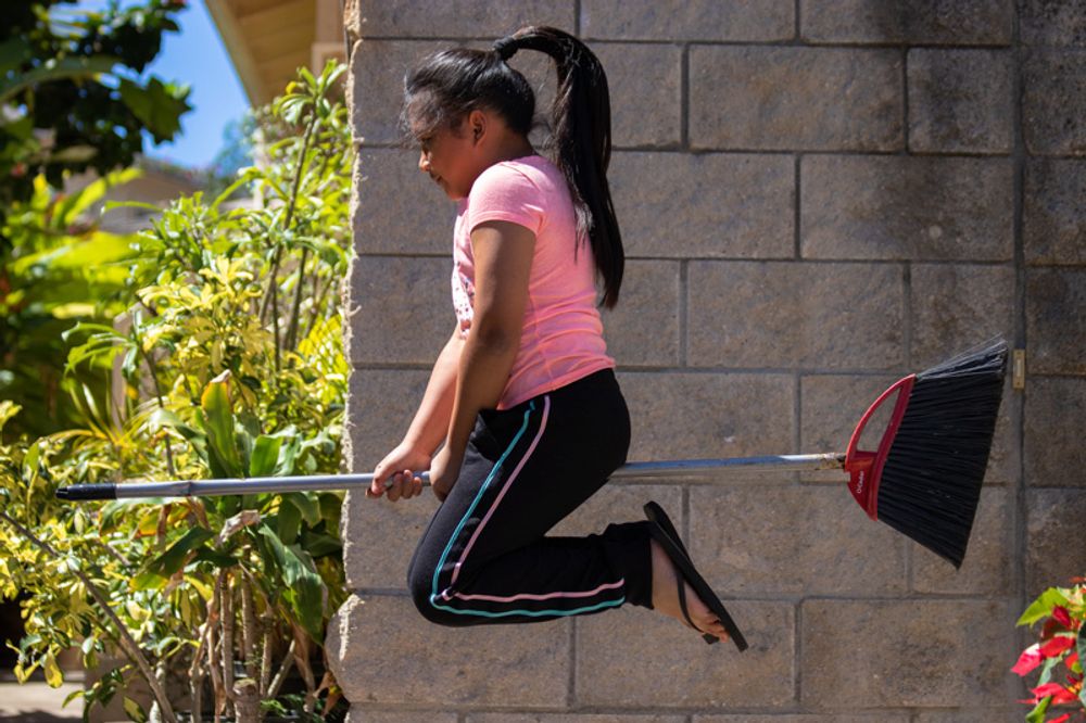 Girl riding a broomstick.