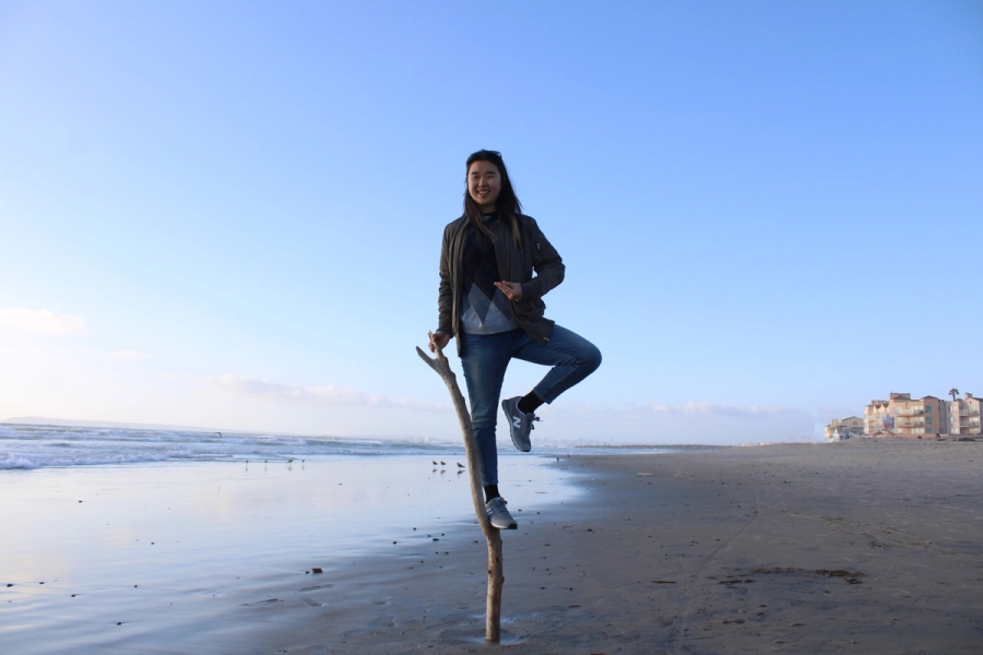 Girl doing a ballerina move while standing on a stick.