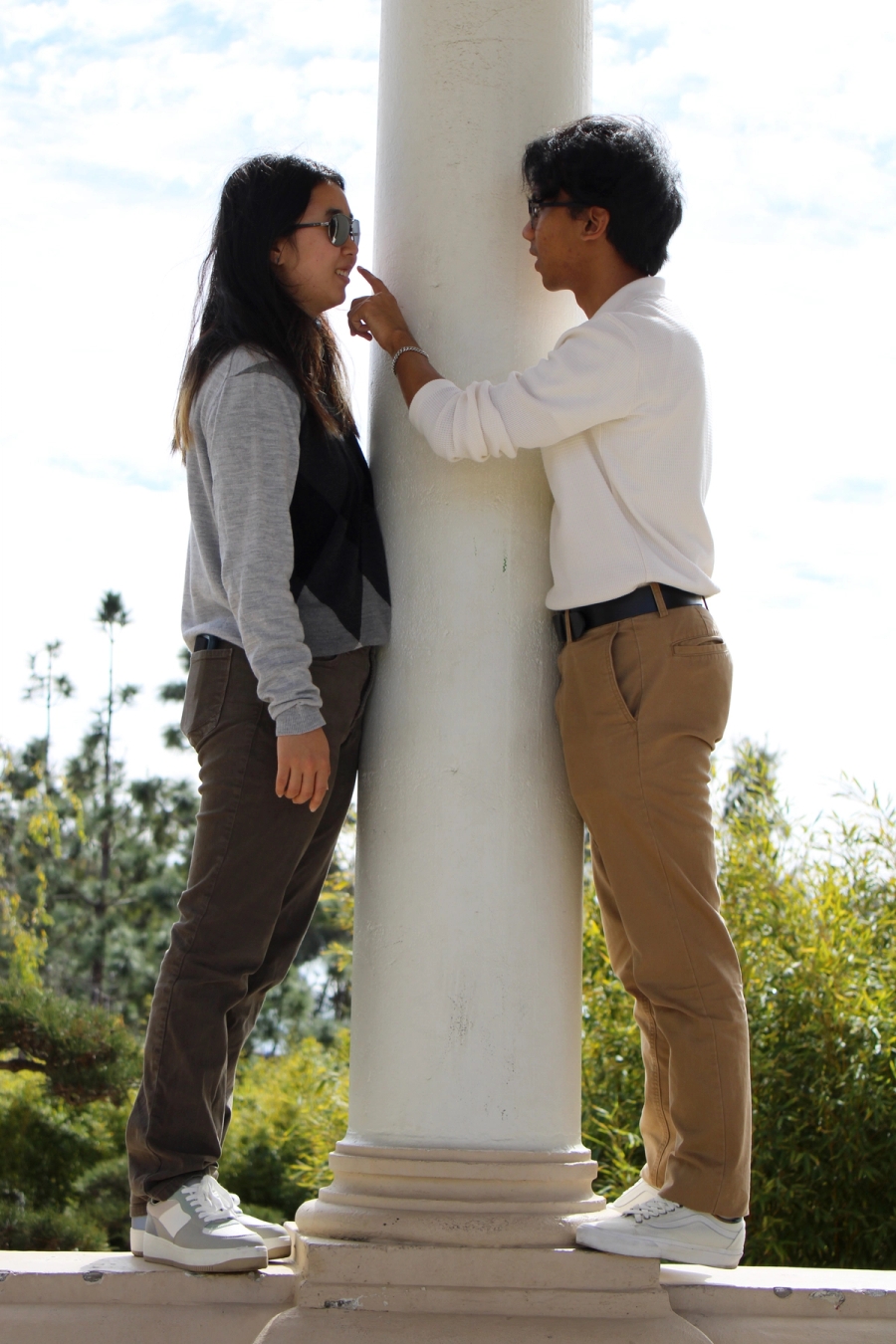 Boy touching girl's nose.
