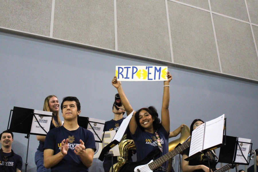 Girl holding "Rip 'Em" sign.