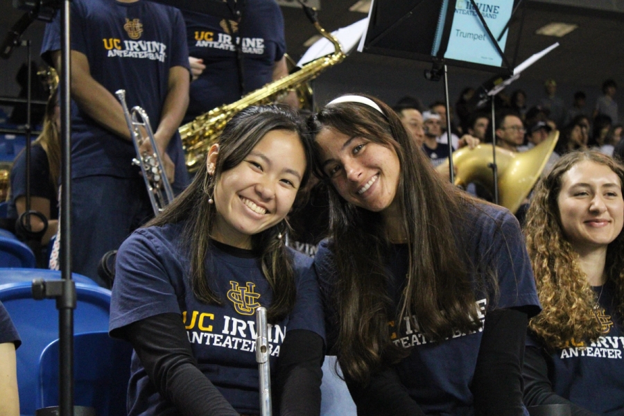 Two girls with flutes smiling.