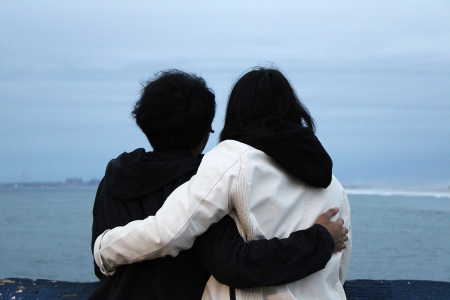 Girl and boy holding each other.