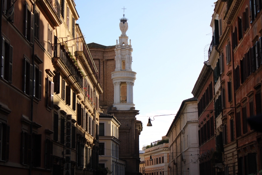 White statue in between buildings.