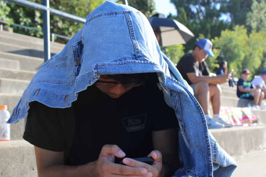Boy under denim jacket.