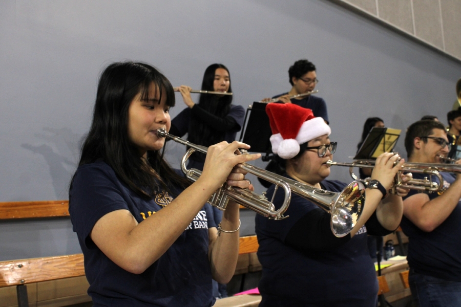 Trumpets playing (one wearing a Santa hat).