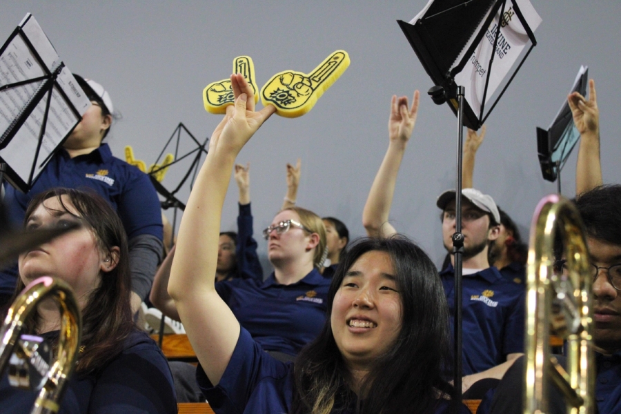 Girl zotting with 2 foam fingers.