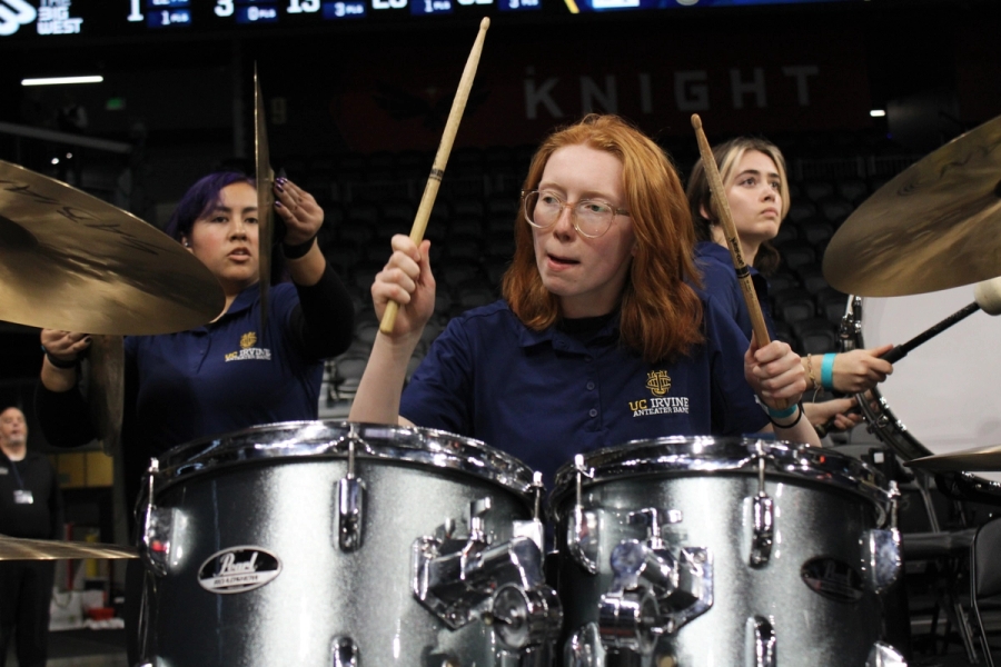 Three percussion girls playing their instruments.