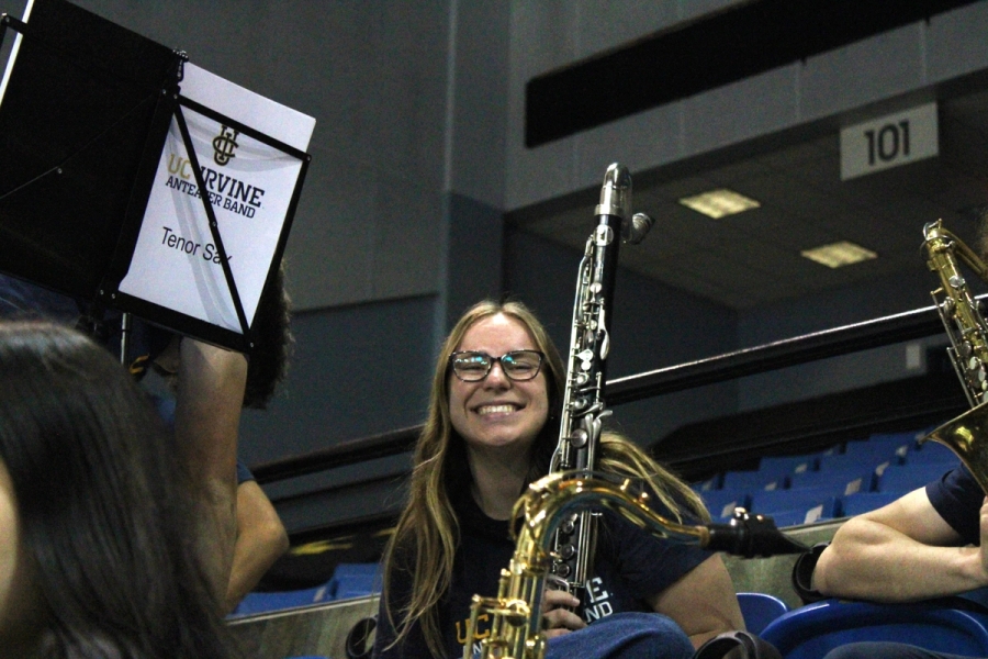 Girl with bass clarinet smiling.