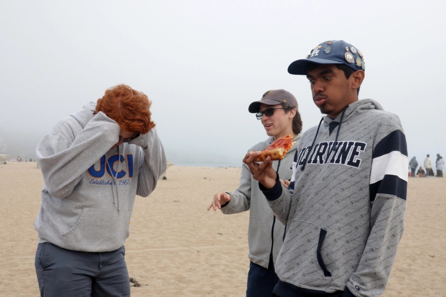 Three boys eating pizza.