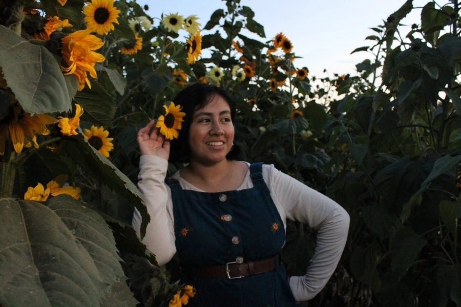 Girl posing with sunflowers.
