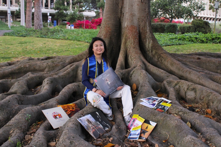 Girl posing with records and playbills.