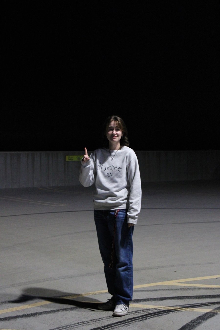 Girl holding up one finger.