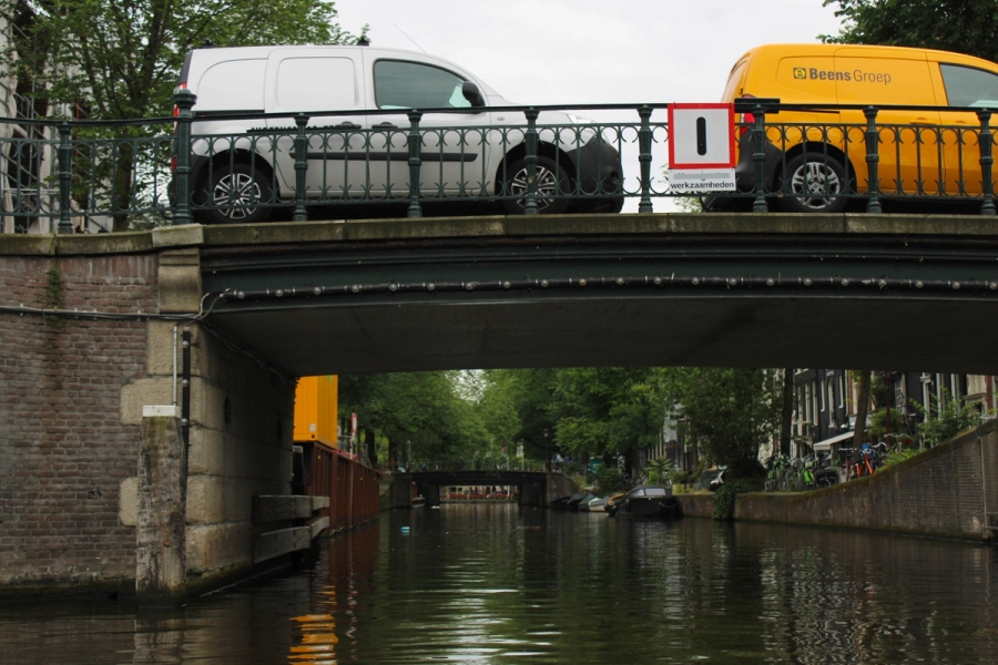 River POV of bridge with cars.
