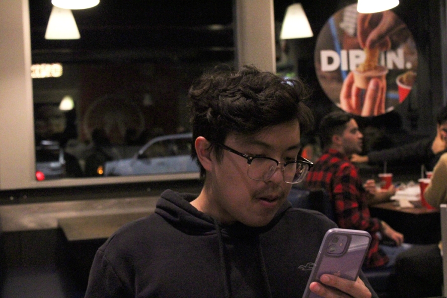 Boy looking at phone.