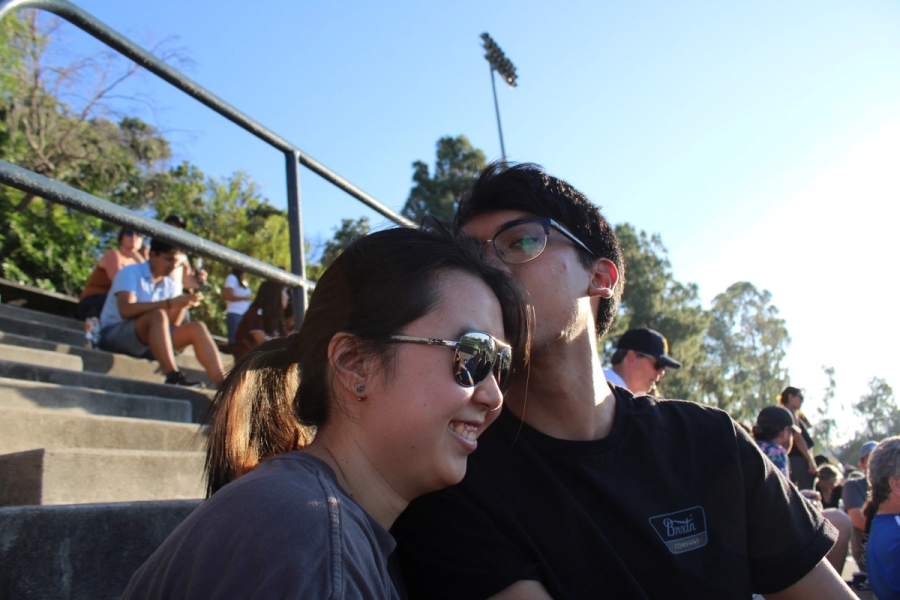 Boy kissing girl's head.