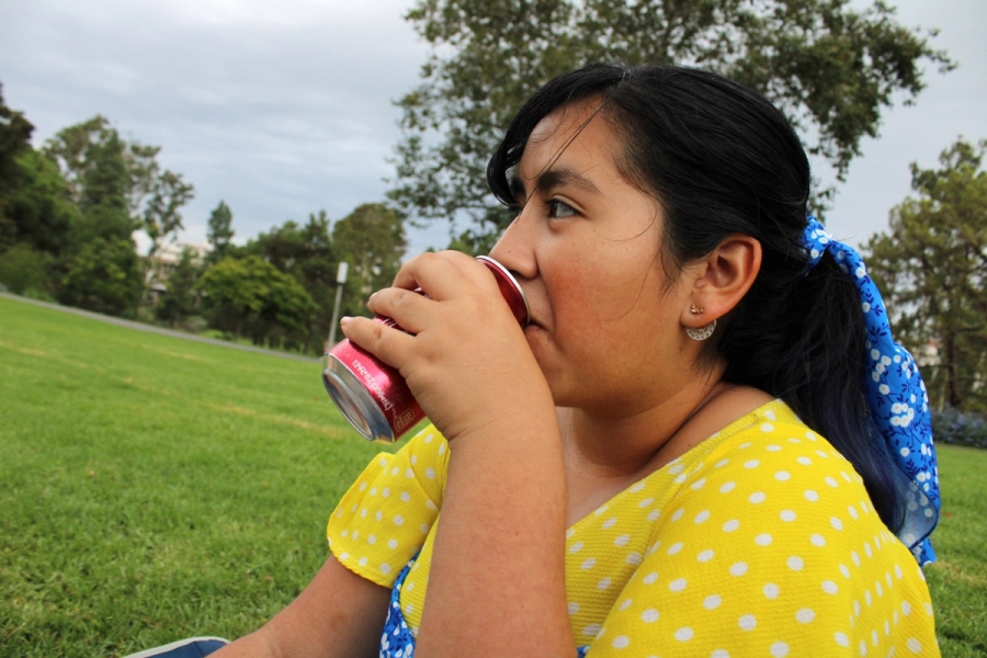 Mexican girl drinking soda.