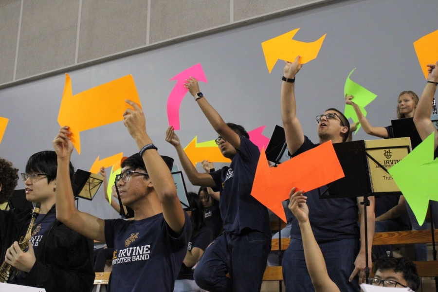 Front side POV of band holding up arrows.
