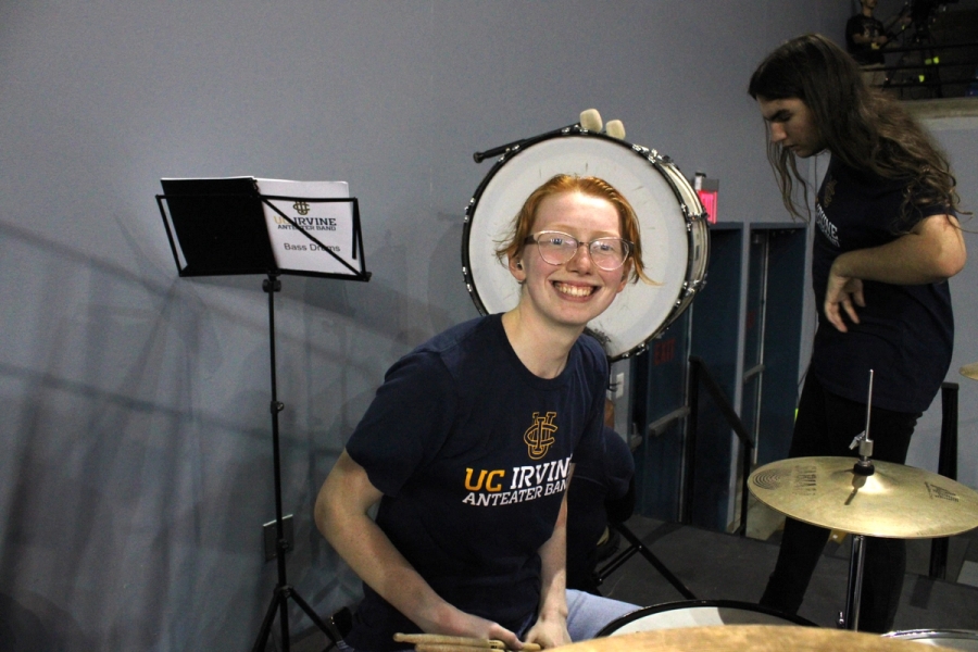 Girl on drums smiling.