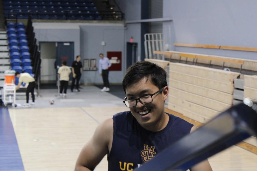 Boy smiling with sleeveless band shirt.