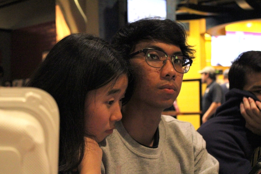 Girl leaning on boy's shoulder.