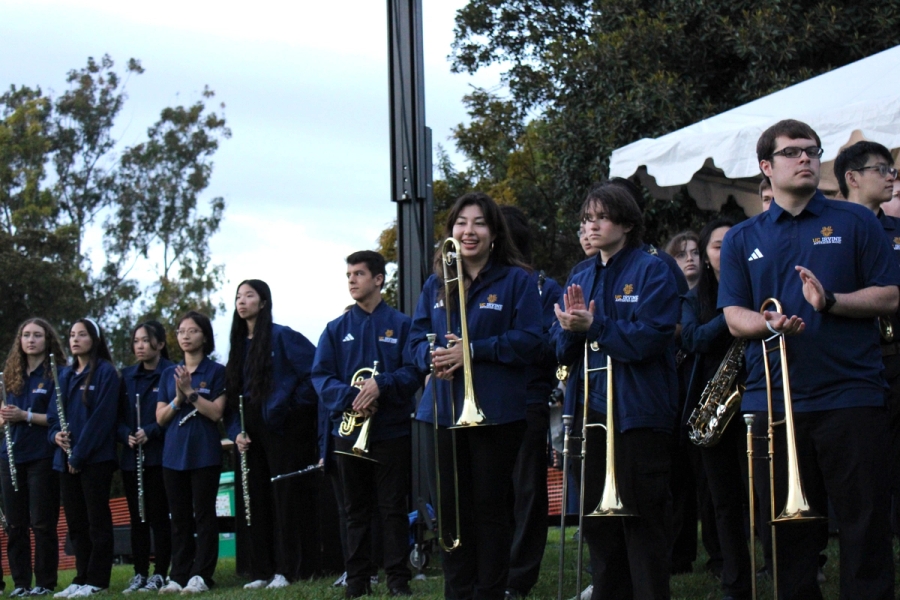 Trombones and flutes standing.