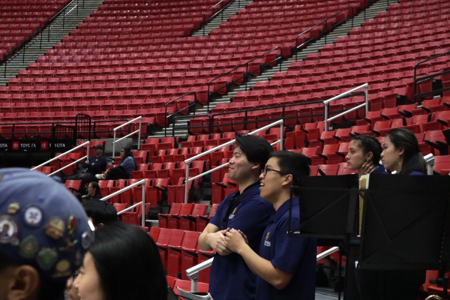 Two boys watch the court.