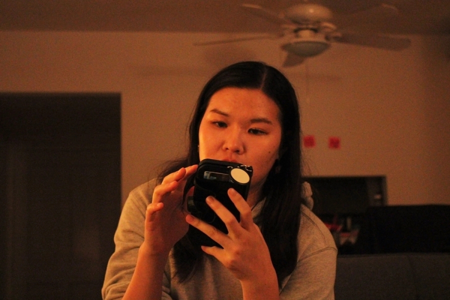 Girl tapping on her phone.