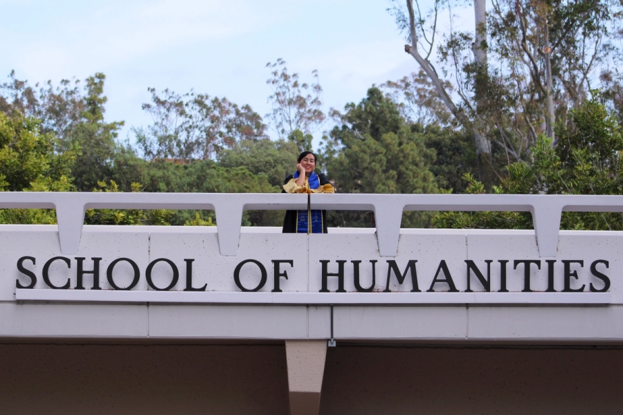 Girl in the middle of school sign.