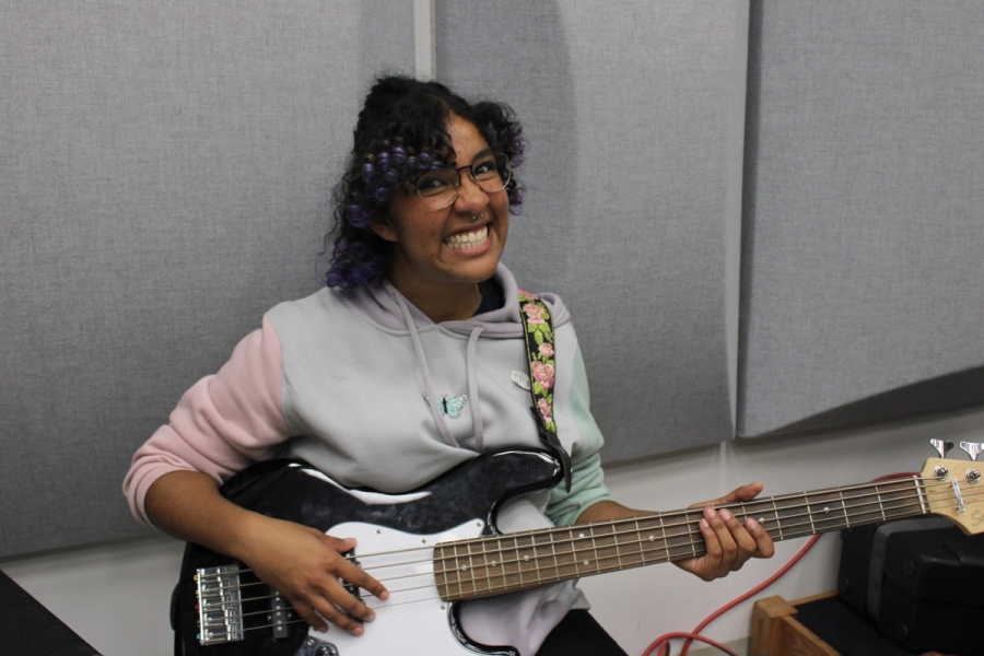 Girl with bass smiling.