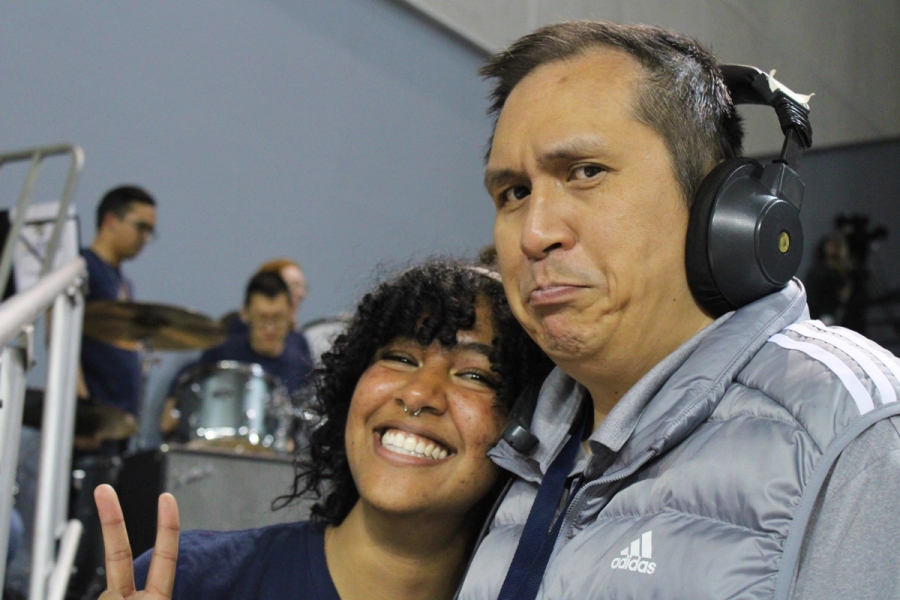 Girl posing with band director.