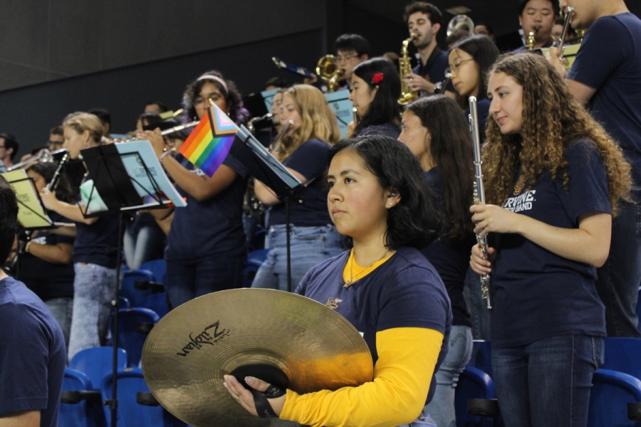 Girl holding cymbals.