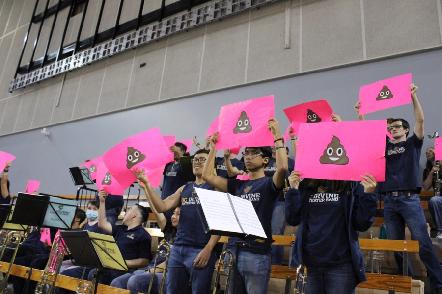Low POV of the band holding up poop emojis.