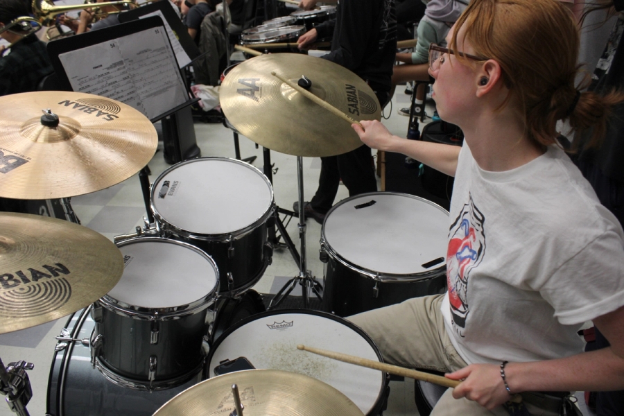 Girl playing the drums.