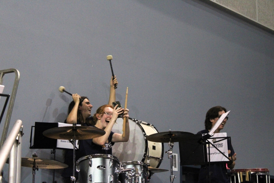 Girl on drums taking pic of Jumbotron.