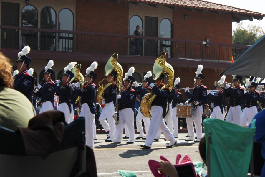 Band playing and marching through the street.