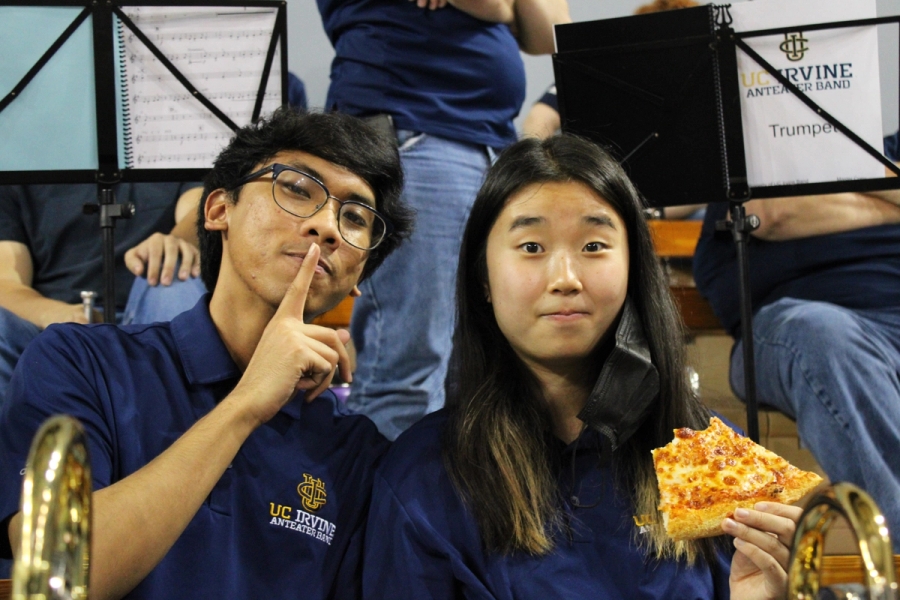 Boy mogging and girl with pizza.