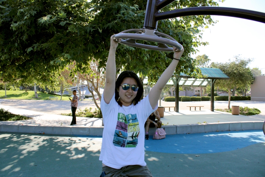Asian girl swings on gear.