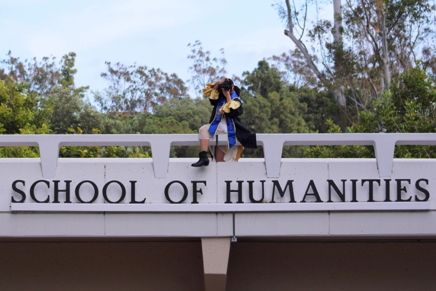 Girl taking a photo on school sign.