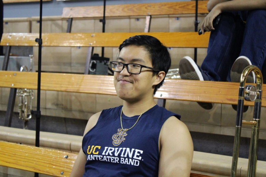 Boy with sleeveless band shirt side-eyeing.