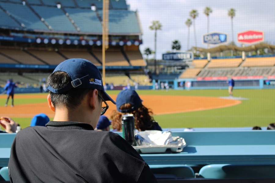 Back POV of UCLA baseball stadium behind fan.