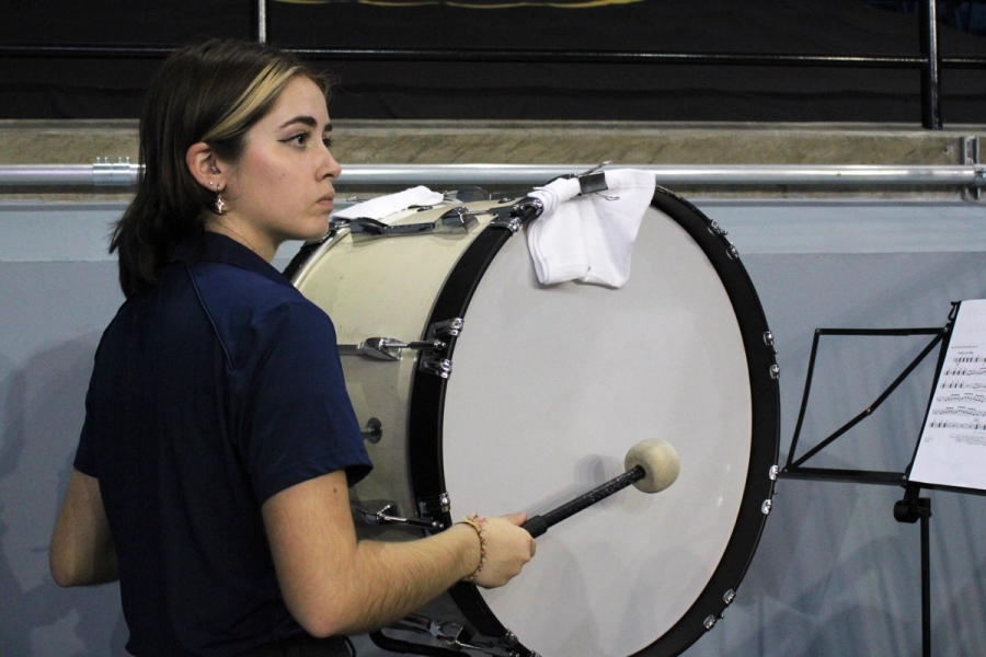 Girl playing bass drum.