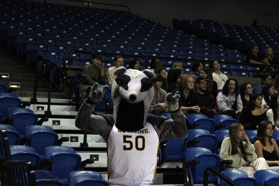 Peter holding "zots" in front of the stands.