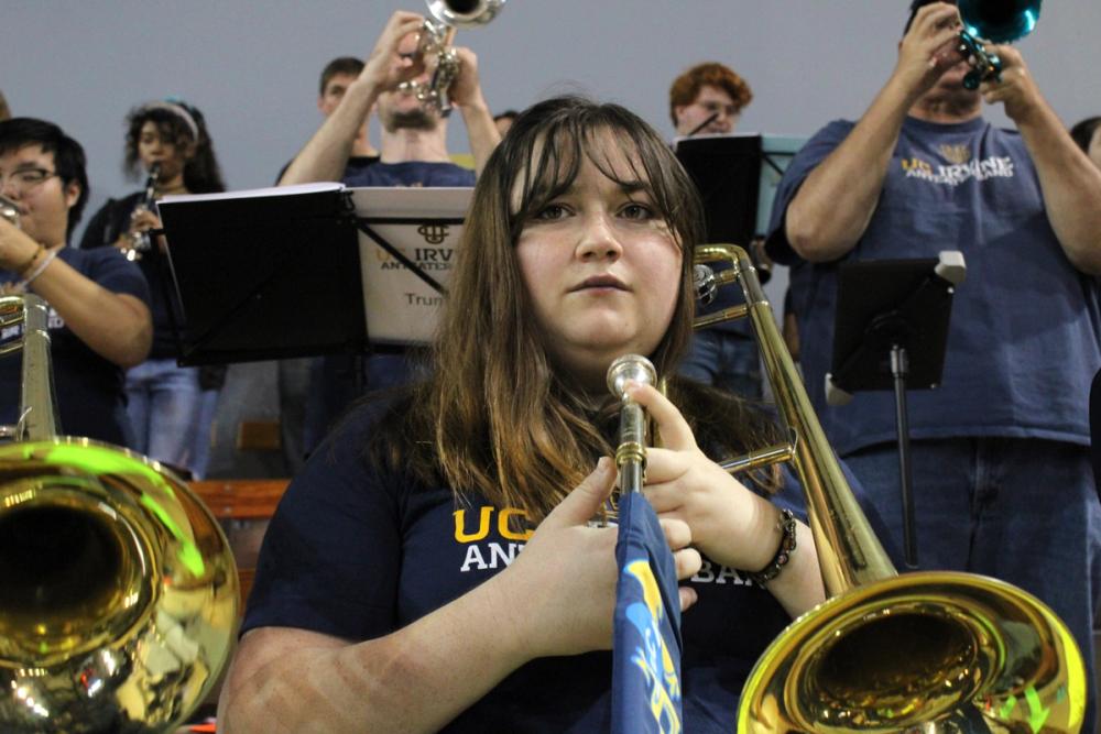 Girl staring into camera while holding trombone.