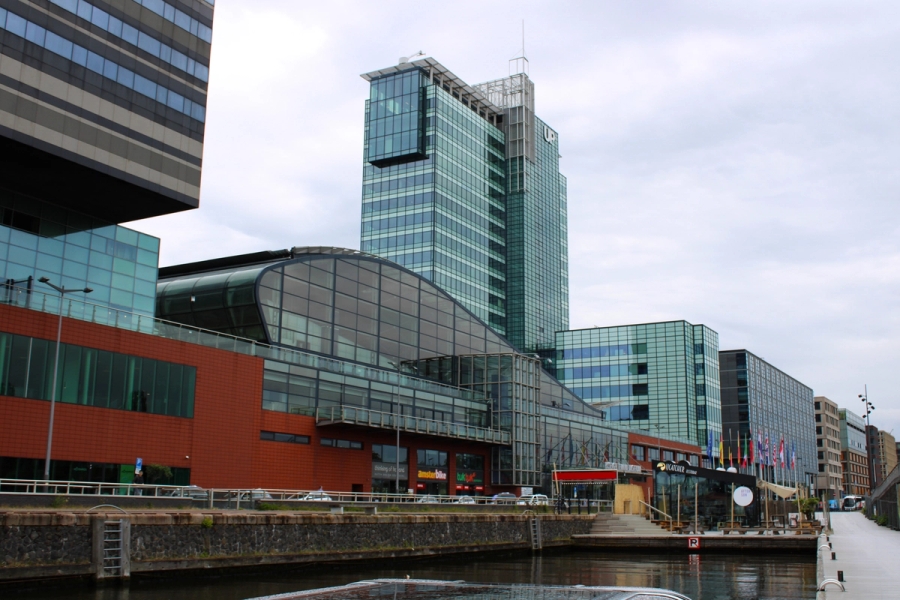 Modern glass building on side of river.